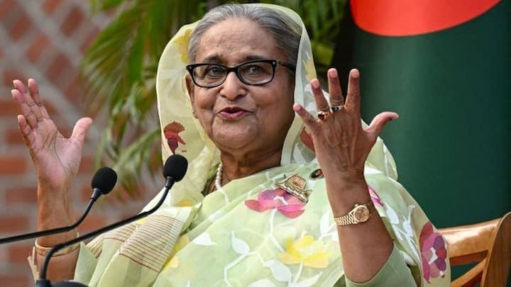 Laptop screen showing a virtual speech, Hasina's portrait, and India's Parliament in the background.